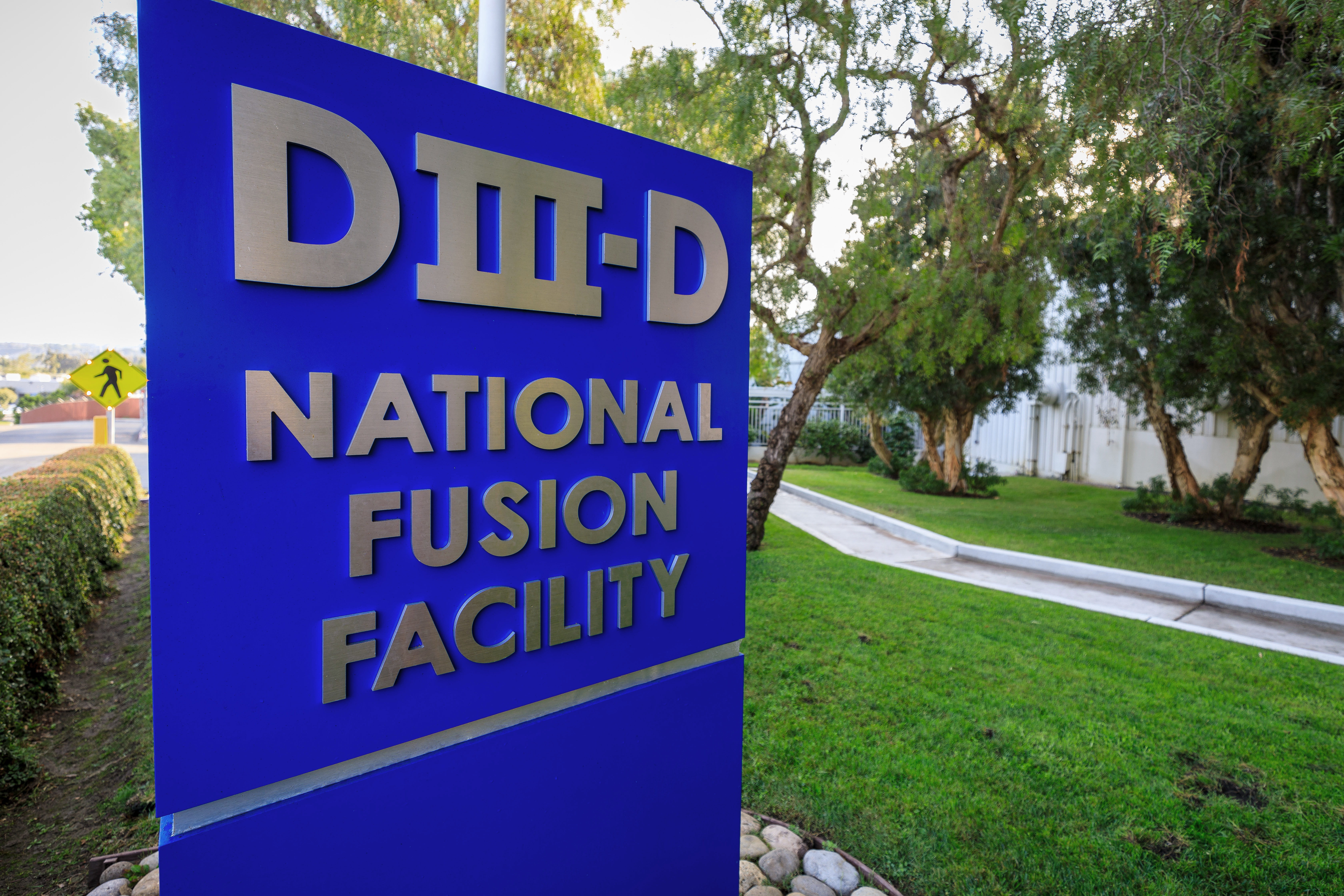 A blue sign reading "DIII-D National Fusion Facility"